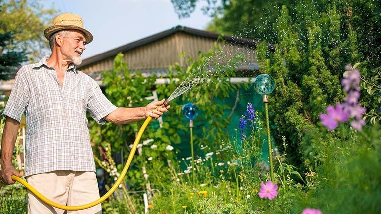 a man watering his garden